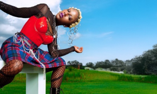 a person posing for a picture with blue skies in the background